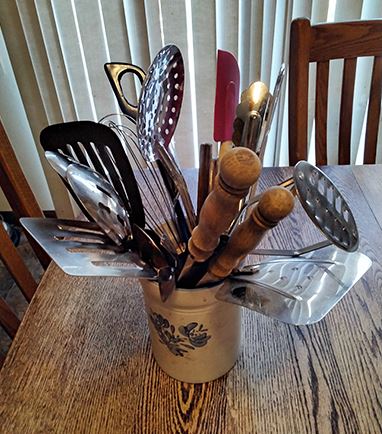 kitchen utensils crammed into a container