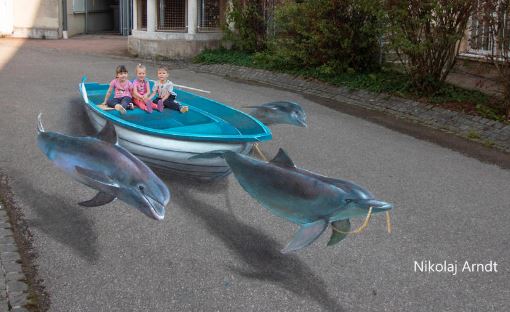 Nikolaj Arndt street art dolphins pulling a boat